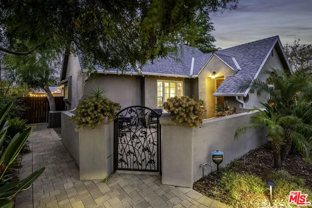 a view of a house with potted plants