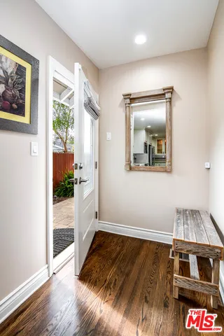 a kitchen with granite countertop a stove and a wooden floor