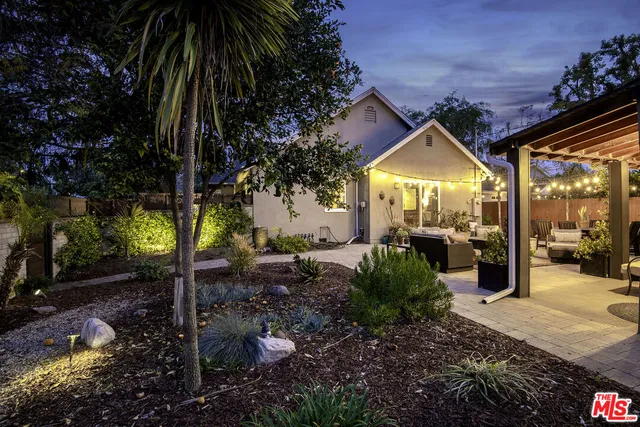 a view of a chairs and table in backyard
