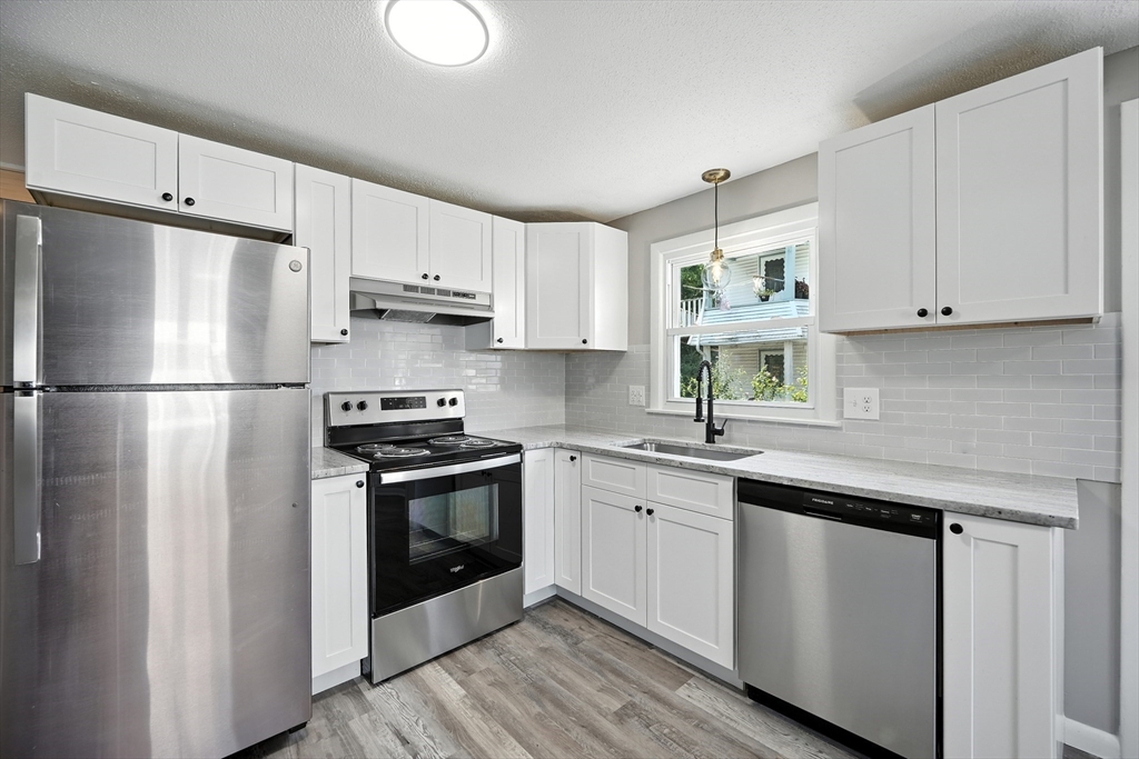 55 Governor Street Springfield, MA 01104 - Photo 1 of 28 a kitchen with stainless steel appliances granite countertop a sink stove and refrigerator