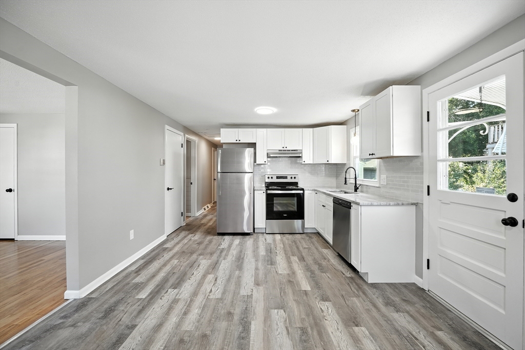 55 Governor Street Springfield, MA 01104 - Photo 6 of 28 a kitchen with a white cabinets and wooden floor