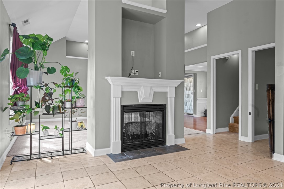 176 Clearbrook Place Raeford, NC 28376 - Photo 11 of 36 a living room with a fireplace and a potted plant