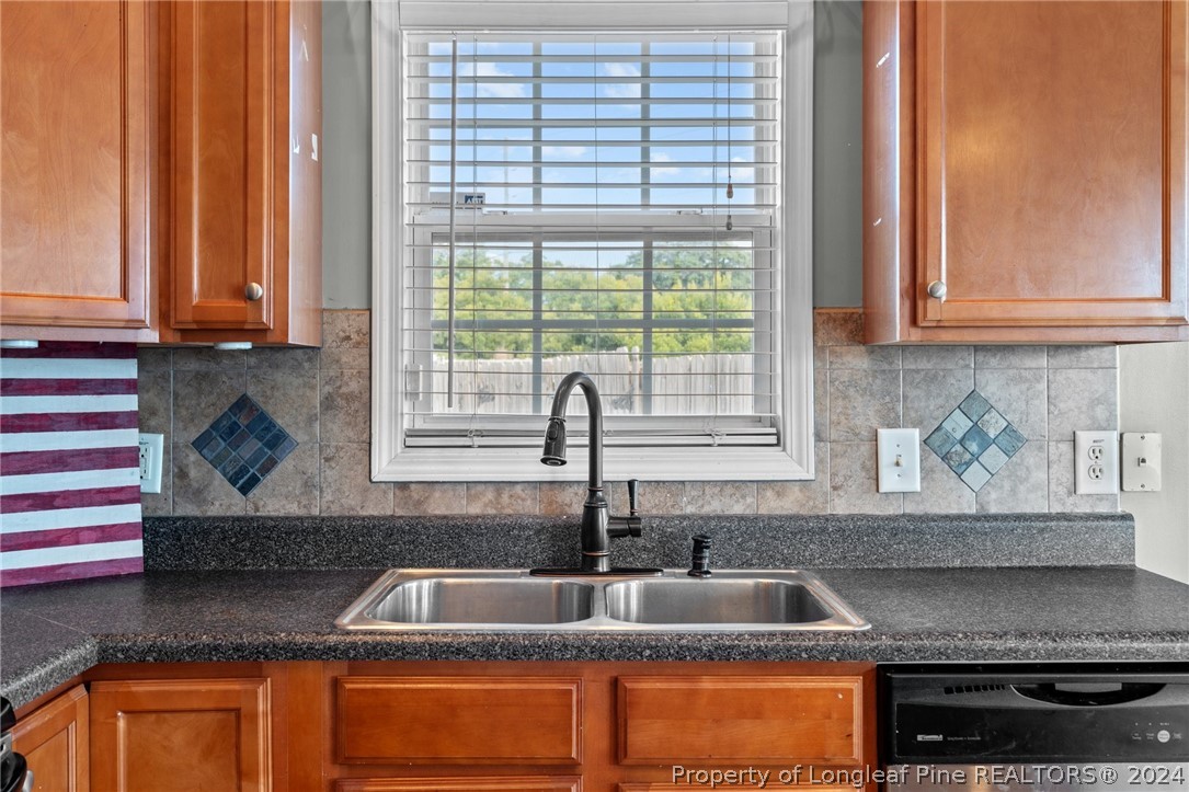 176 Clearbrook Place Raeford, NC 28376 - Photo 15 of 36 a kitchen with granite countertop a sink and a window