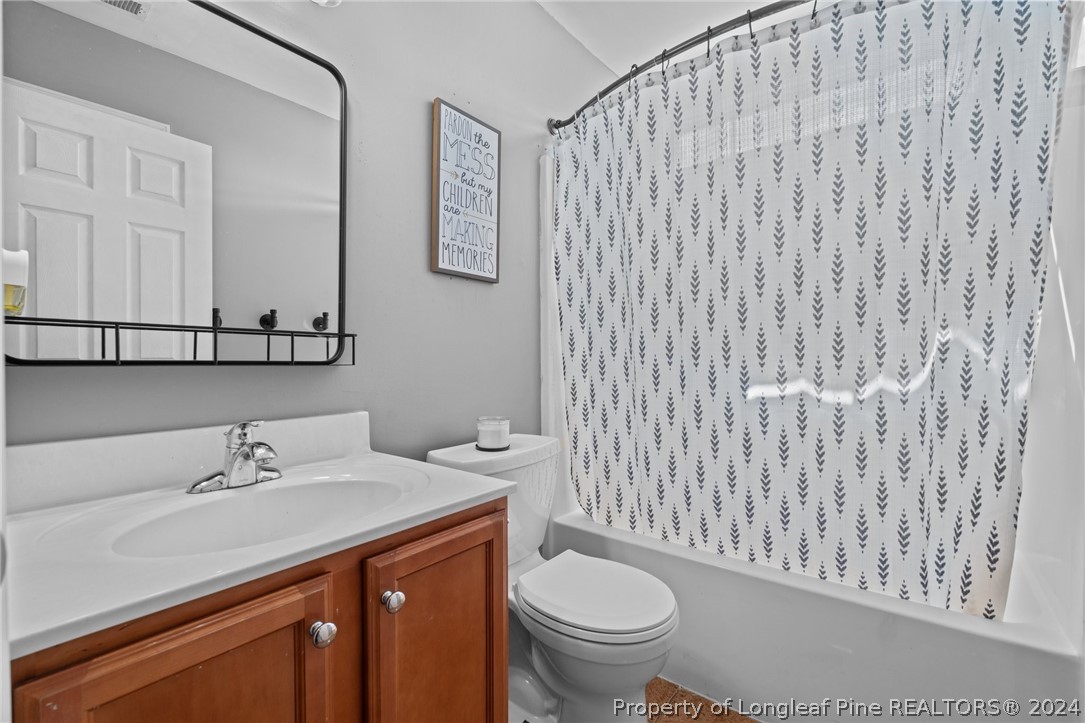 176 Clearbrook Place Raeford, NC 28376 - Photo 20 of 36 a bathroom with a sink a toilet and a mirror