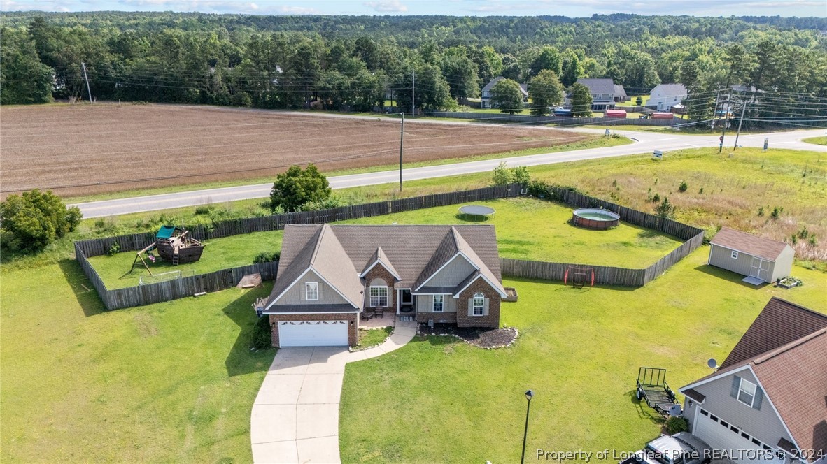 176 Clearbrook Place Raeford, NC 28376 - Photo 2 of 36 a view of a swimming pool with a patio and plants