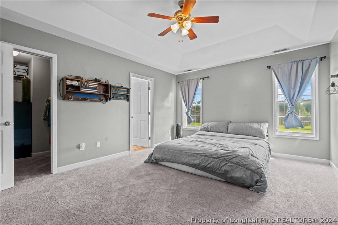 176 Clearbrook Place Raeford, NC 28376 - Photo 25 of 36 a bedroom with a bed and a chandelier