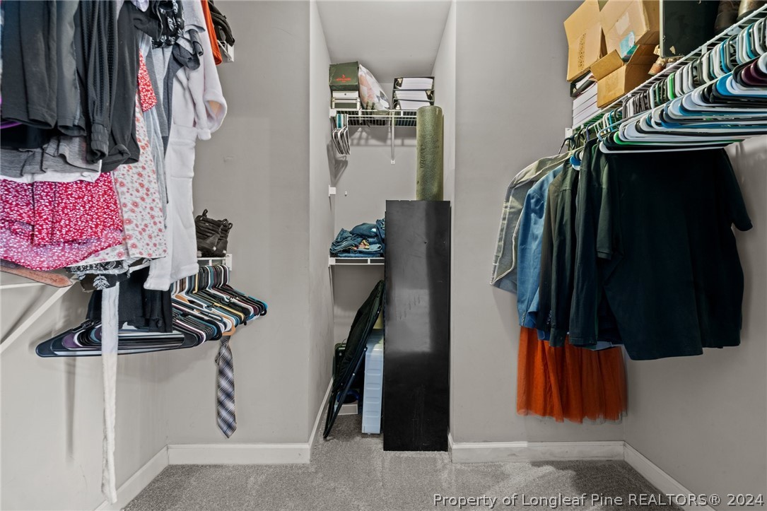 176 Clearbrook Place Raeford, NC 28376 - Photo 26 of 36 a view of walk in closet with clothes and shoes