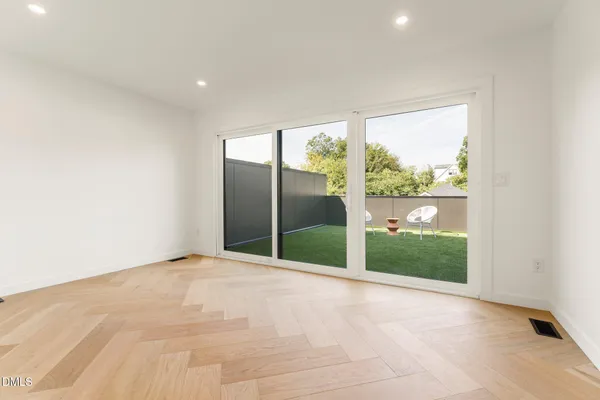 a large kitchen with stainless steel appliances kitchen island a large counter top and a fireplace