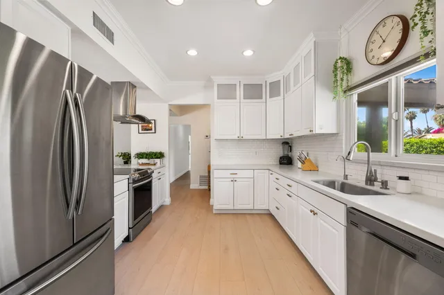 a living room with furniture a flat screen tv and a floor to ceiling window