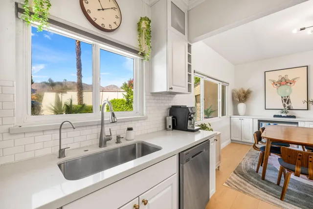 a bedroom with a bed a flat screen tv and a couch