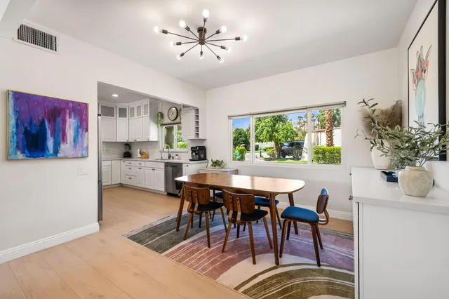 a bedroom with two beds and a chandelier