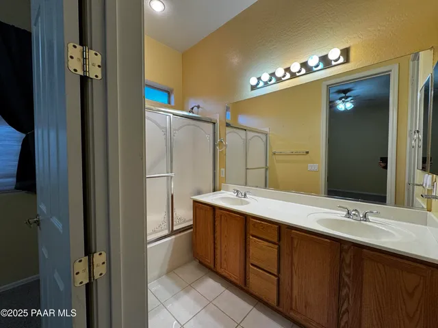 a bathroom with a double vanity sink and a mirror