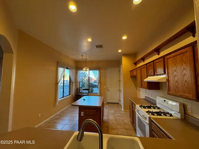 a kitchen with sink and stove