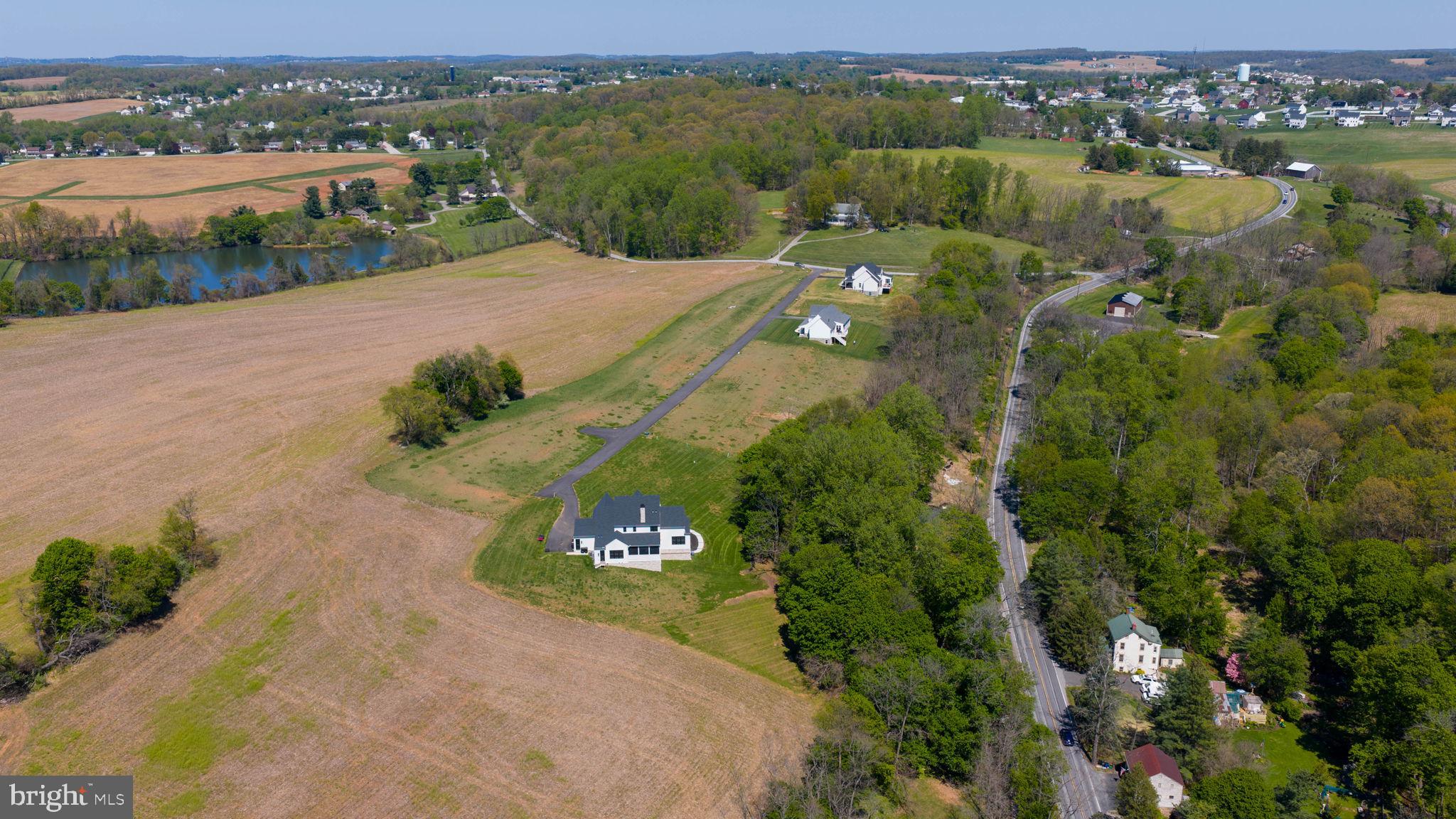 7 Harambe Overlook Railroad, PA 17355 - Photo 7 of 15 an aerial view of green landscape with trees houses and lake view