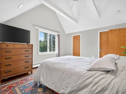 a bedroom with a bed and a flat tv screen