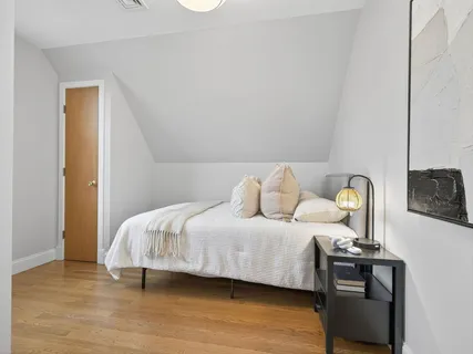 a bedroom with a bed and dresser