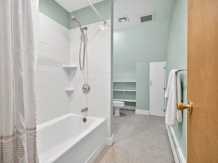 a bathroom with a tub a sink and a shower