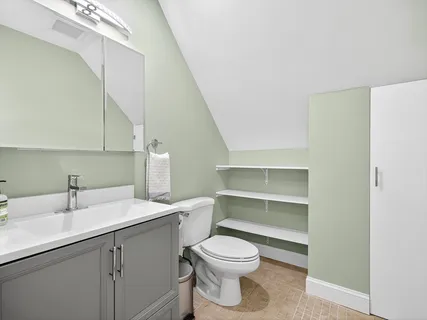 a bathroom with a sink a toilet and vanity