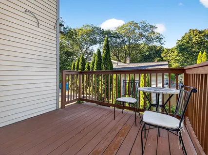 a view of a deck with furniture and wooden floor