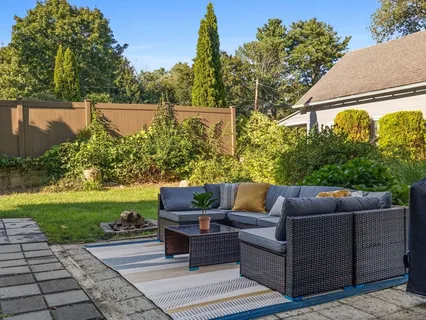 a view of patio with couches and a fire pit
