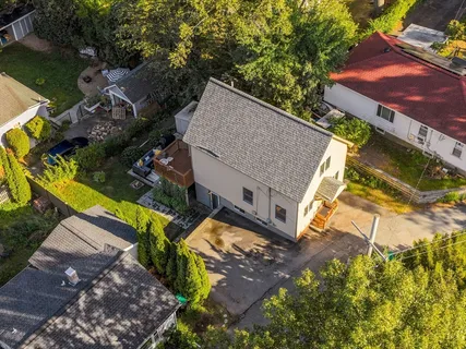 an aerial view of a house with a yard