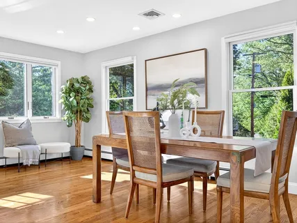 a view of a dining room with furniture window and wooden floor