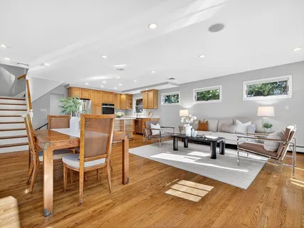 a living room with furniture a rug and a table