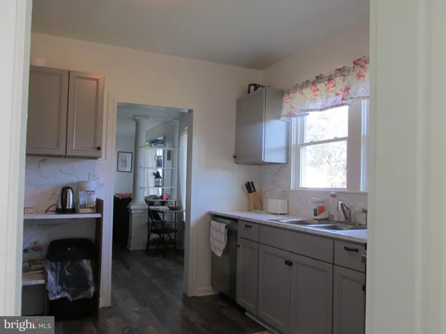 a kitchen with a sink cabinets and window