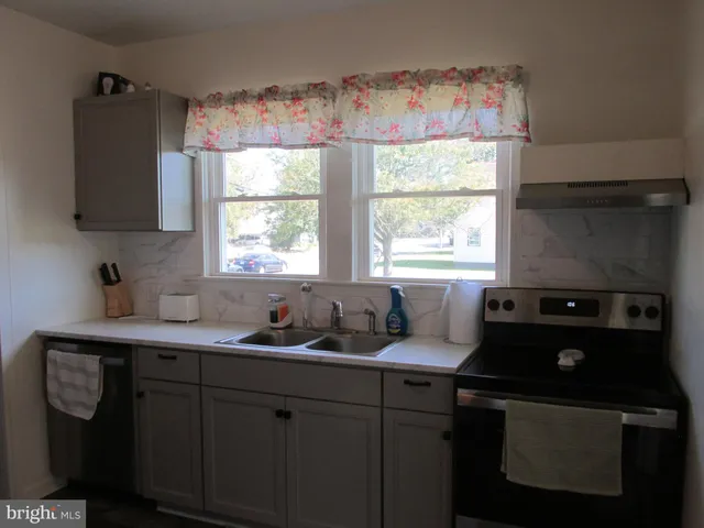 a kitchen with a sink a window and appliances