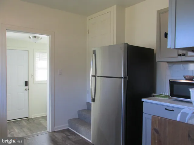 a kitchen with a refrigerator and cabinets