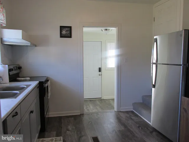 a kitchen with a refrigerator and a sink