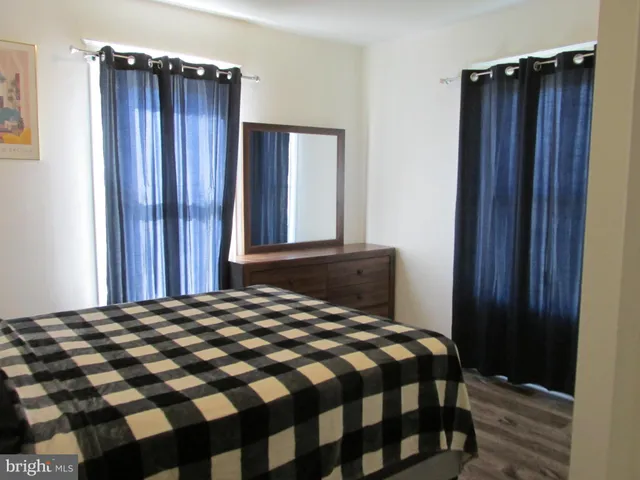 a bedroom with a bed and a mirror