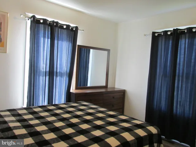 a bedroom with a bed and a mirror