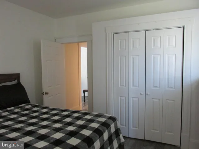 a bedroom with a bed and a closet