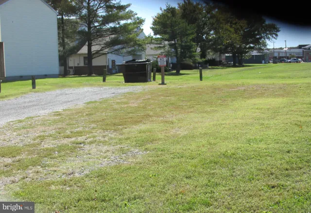 a backyard of a house with lots of green space and fountain