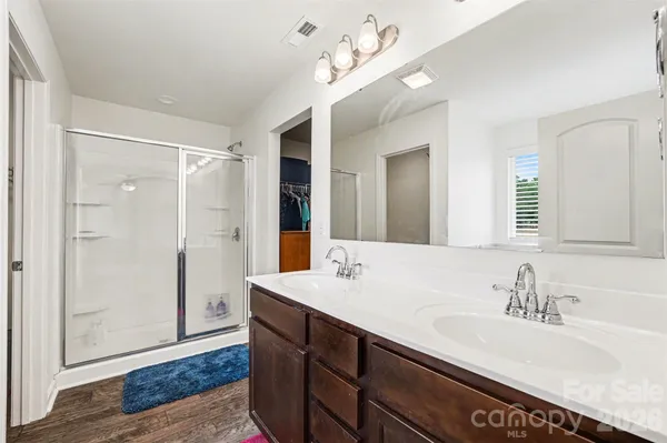a bathroom with a sink double vanity and a shower