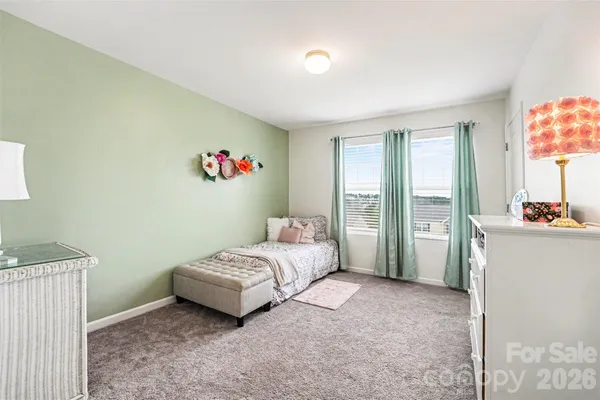 a spacious bedroom with a bed and a cabinets