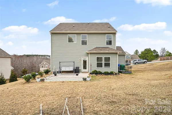 a front view of a house with cars parked