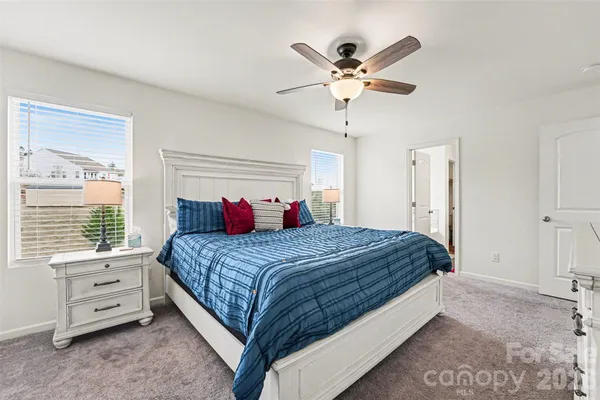 a bedroom with a large bed and a window