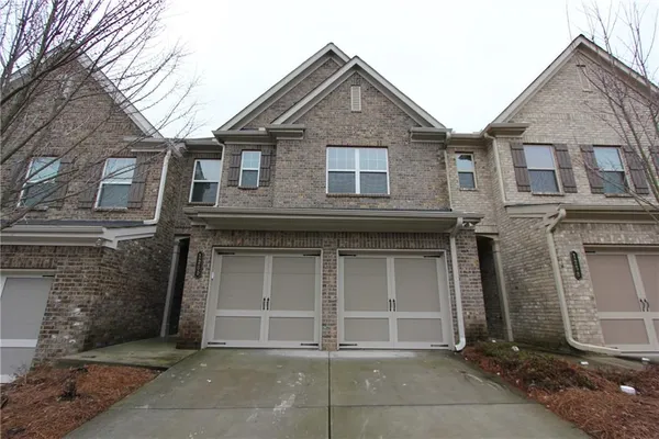 a front view of a house with garage