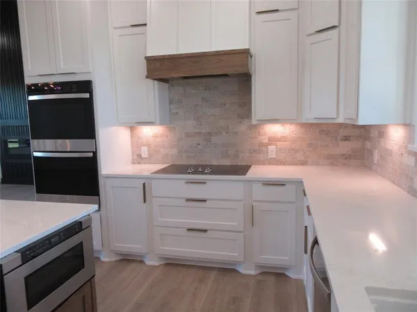 a bathroom with a double vanity sink a toilet and shower