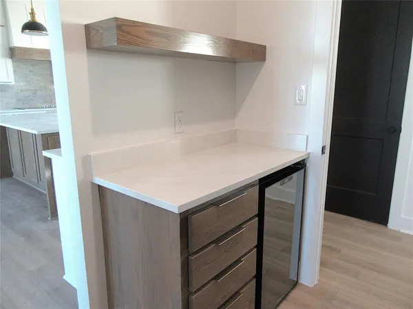 a kitchen with white cabinets and sink