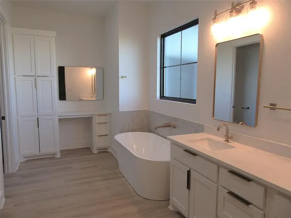 a view of a hallway with closet and wooden floor