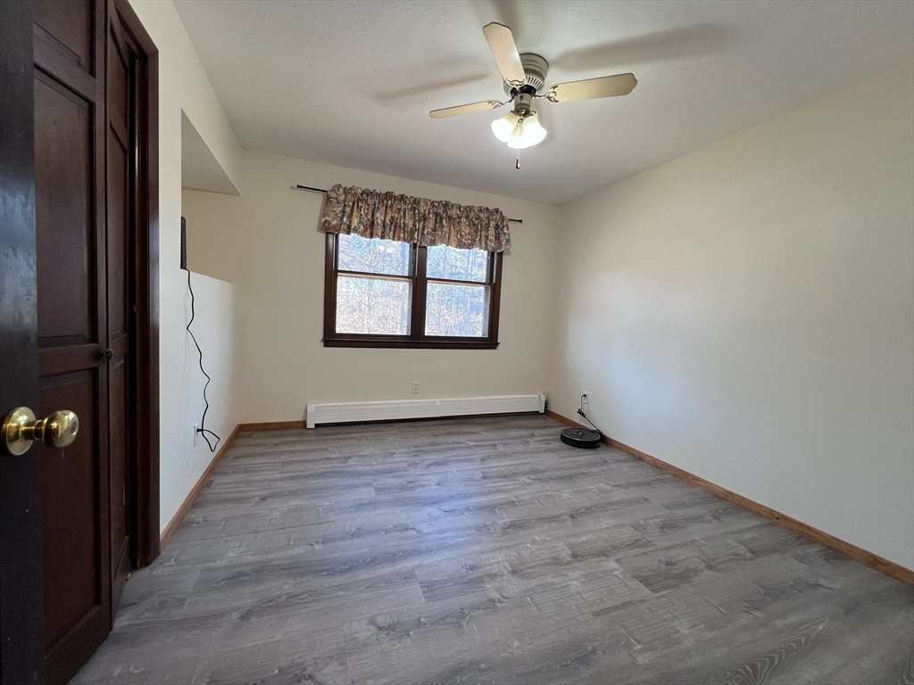 23 Hospital Road Templeton, MA 01436 - Photo 12 of 32 an empty room with windows and fan