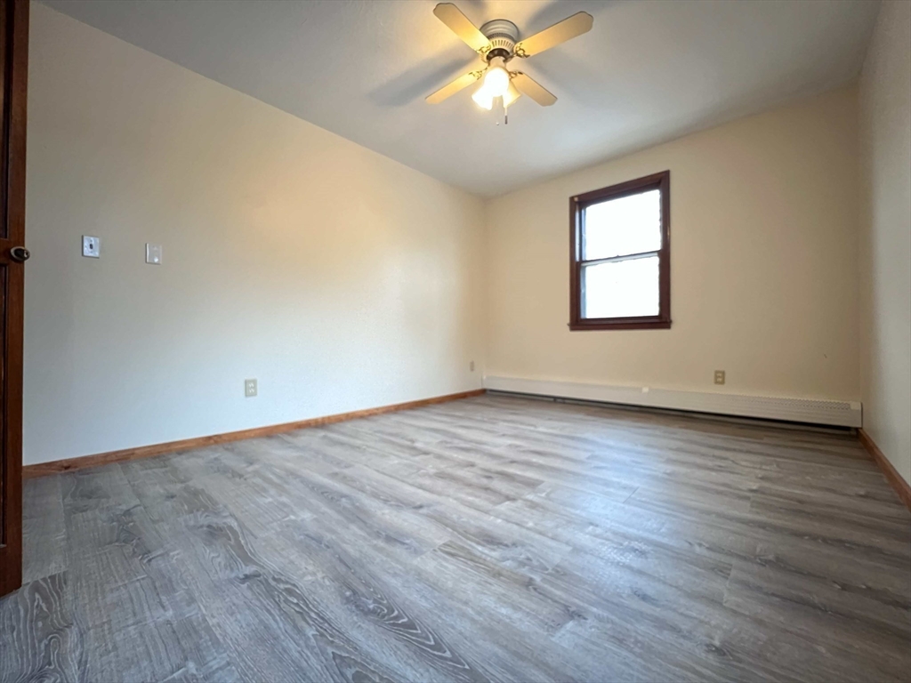 23 Hospital Road Templeton, MA 01436 - Photo 19 of 32 an empty room with wooden floor fan and windows
