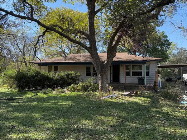 a view of a house with backyard garden and sitting area