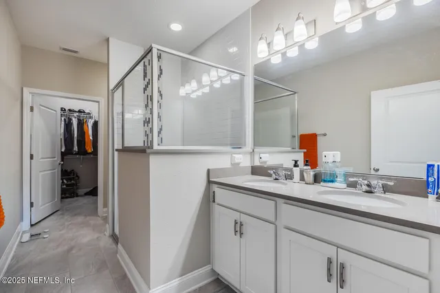 a bathroom with a sink double vanity and shower