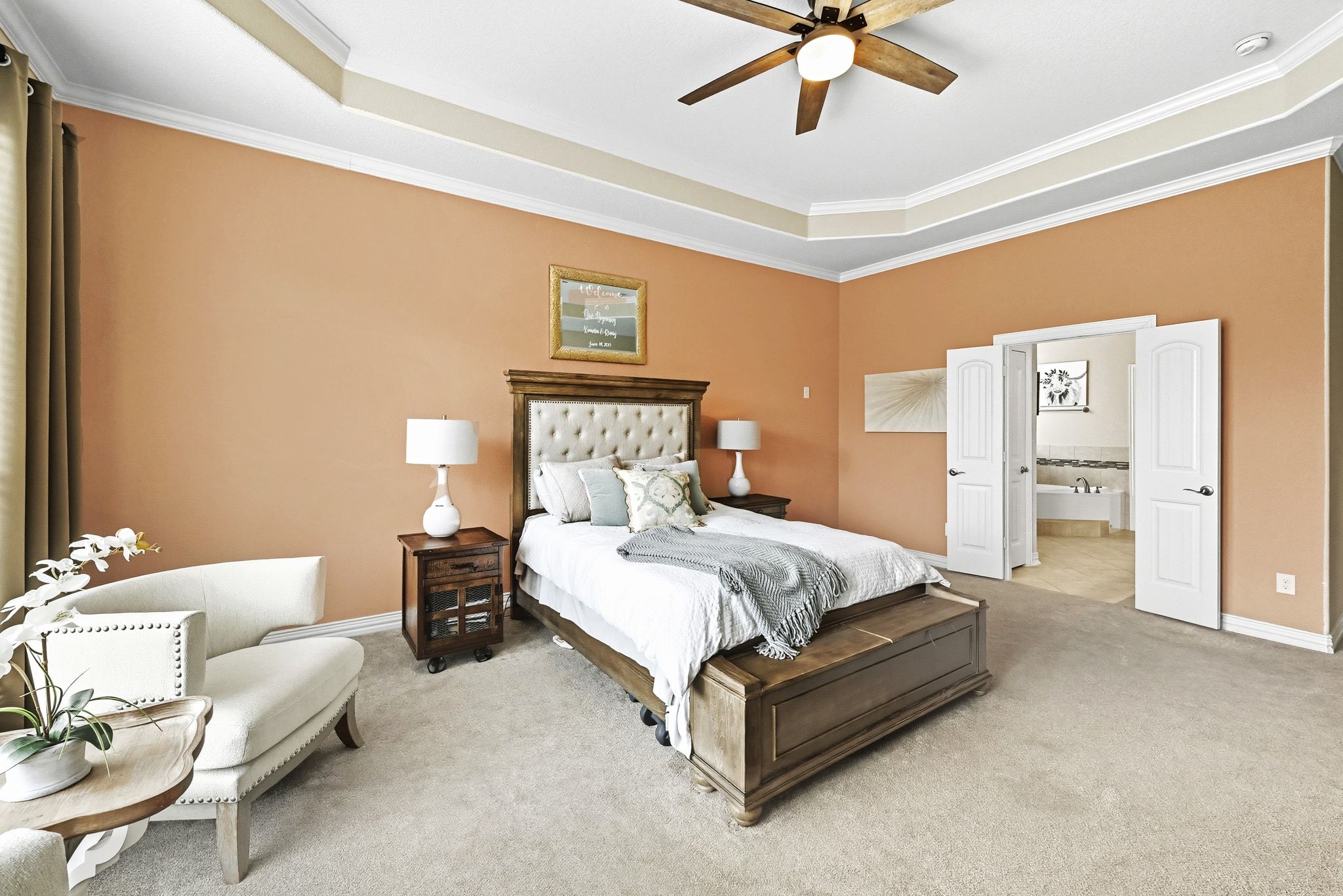 19620 Stanton Drew Pflugerville, TX 78660 - Photo 15 of 33 Bedroom featuring a raised ceiling, carpet flooring, ornamental molding, ceiling fan, and ensuite bath