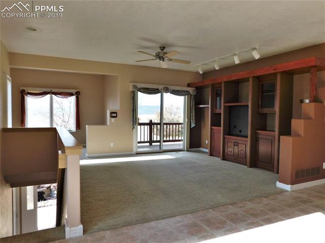 4320 Meridian Road Peyton, CO 80831 - Photo 2 of 28 Spacious living room upstairs w separate sitting area and walkout to covered patio w mountain views