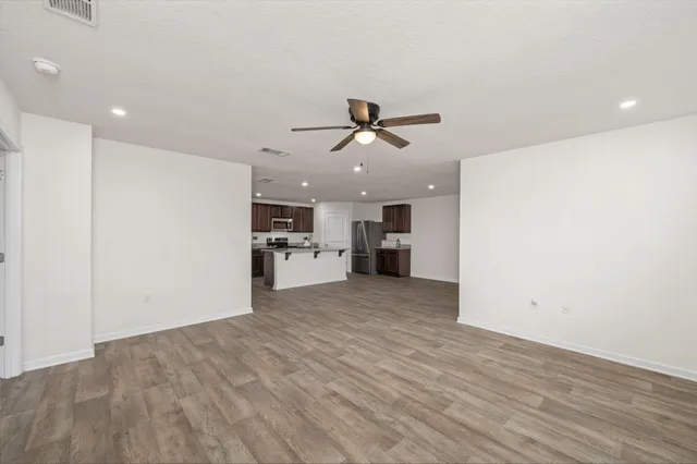 a view of a kitchen with a sink and a refrigerator